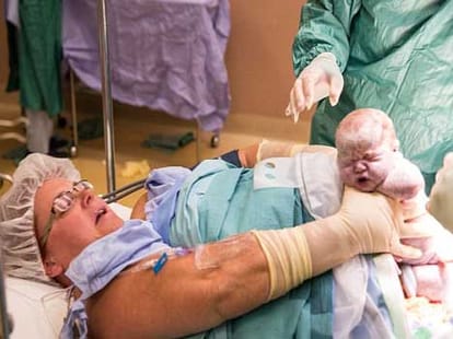 mother reaches her tummy and pulls out twins