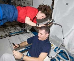 astronauts taking hair cut,