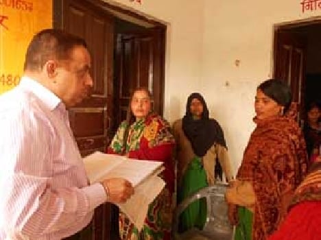 The collector measures woman's blood pressure 