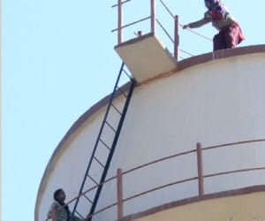 woman climb on water tank.