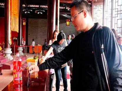 man donates his iphone in temple