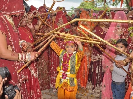 holi celebration with chid in form of lord krishna