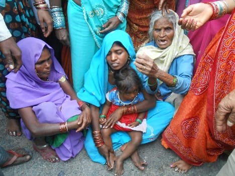 Imposed on the highway jammed with bodies of villagers