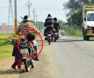 Man ties up daughter on motorbike and  takes her to school