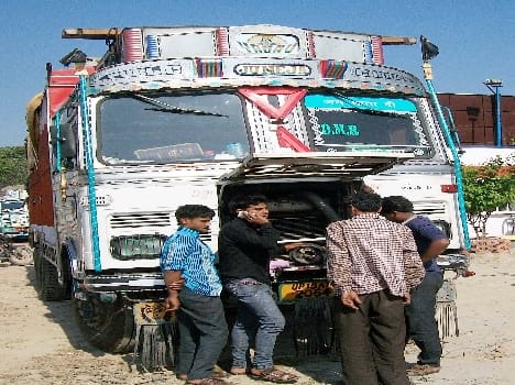 The truck's driver-helper shackled Chinese looted