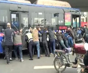 people uplifted bus to save man