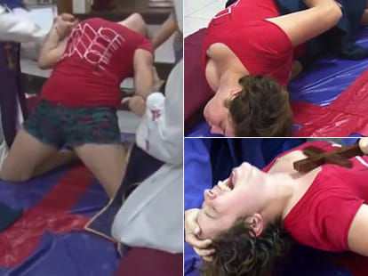 woman is pinned on ground to perform exorcism 