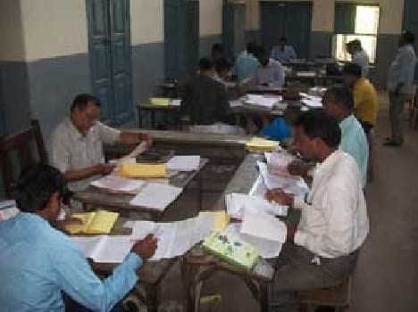 teachers evaluate board copies