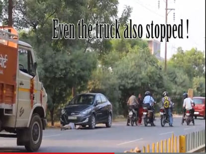 VIDEO: girl beneath a car on a roadside, watch people's reaction