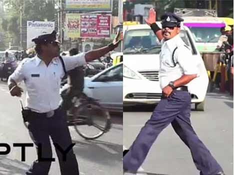 Police cop control traffic by help of michael jackson dance