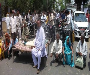 Thana placing the bodies at the gate The villagers had blocked the road