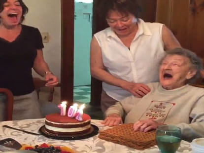 grandma blows out her bday candles, teeth set comes out