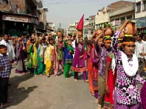 Barefoot devotees come with vase