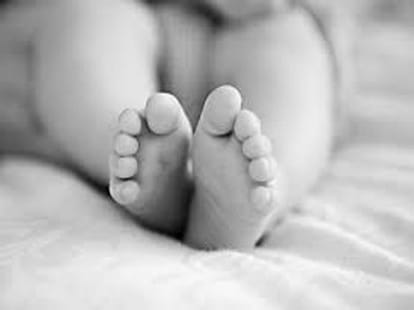 The  innocent baby left at temple in rainy pouring night. 