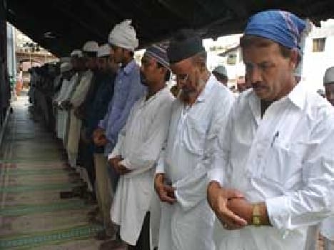 Bent in prayer , Muslim
