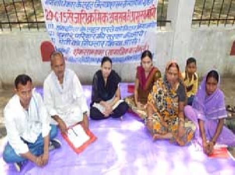 Family sitting on the picket to justice .
