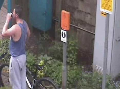 man leaves a child in pram near the railway track