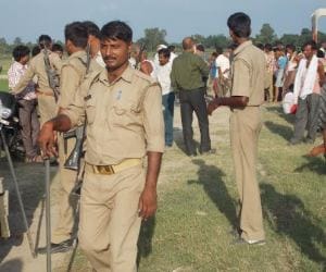 Villagers protest against  a Police team in UP.