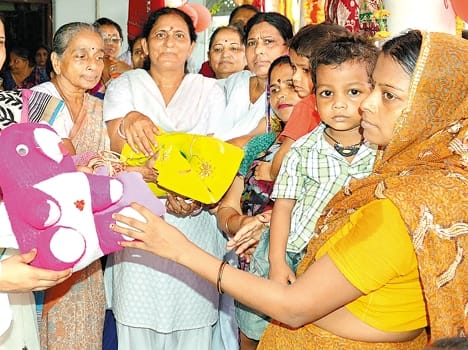 Women saris, toys given to children