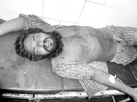 Hands and feet shackled young man thrown