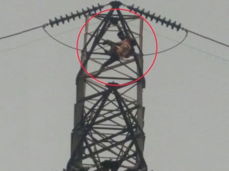 drunk young man climbed on high extension pole for wife