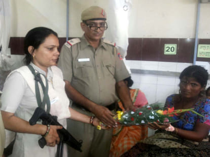 The woman was holding the gun helped in little angel born in moving PCR.