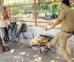 A Police man misbehaved with an old man.