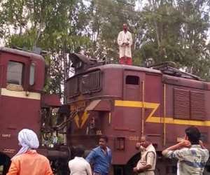 man rides on the roof of goods train in lucknow
