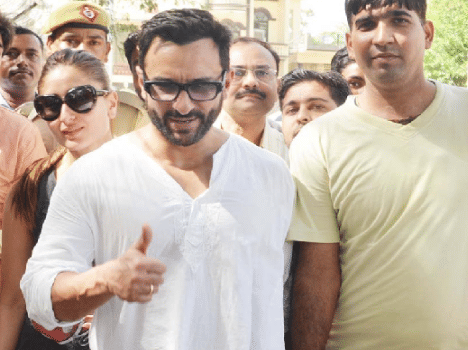 Saif and Kareena surrounded by people.