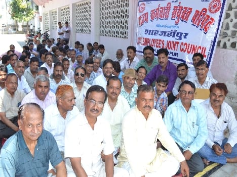 Gandhi statue in front of the silent picketing state workers