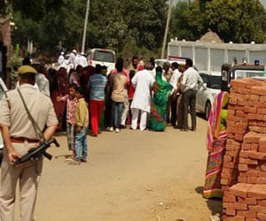police force positioned  in front of college