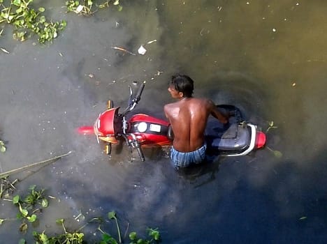 Uncontrollable bike fell down while taking the side of the bridge