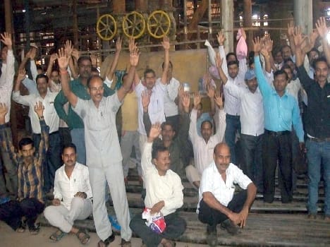 Protesting against the mill management , performance