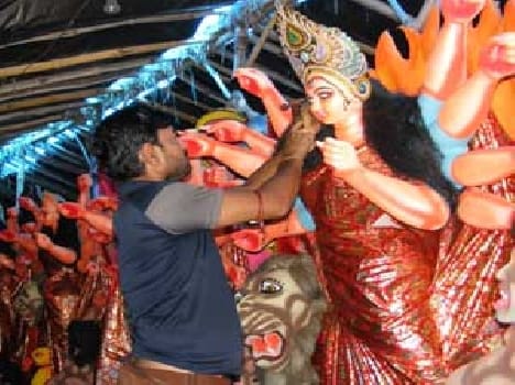 Statue sculptor engaged in finalizing