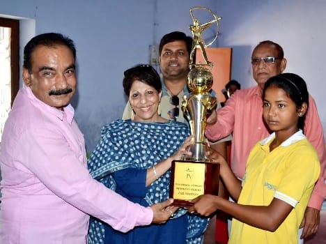 Progress Shakya presented to the Queen Krishna Memorial Running Trophy