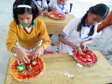 Children given by lighting the lamp of Diwali greetings