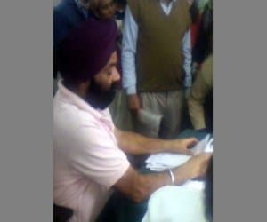chemist writing prescription in doon hospital.