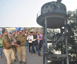 A man climbs at tanki and does stone pelting.