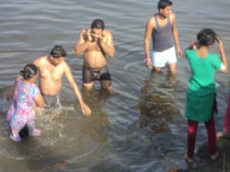 People with a dip in the river made a virtue