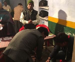 women candidate pour water in ballat box