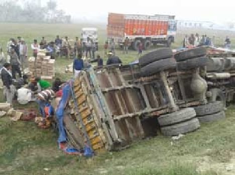Unbalanced wine laden truck overturned into a ravine