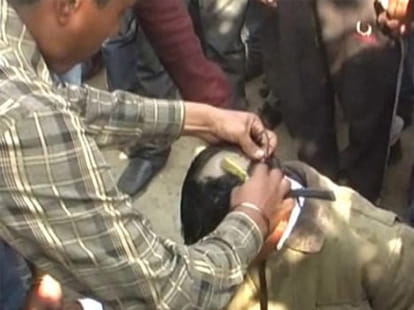 shaved head of accused of Conversion and rotated in town