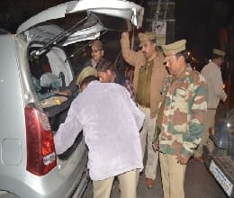 Umbrella of police checking vehicles at crossroads