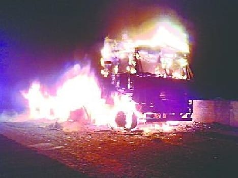 The bus-truck burns after collision, driver killed
