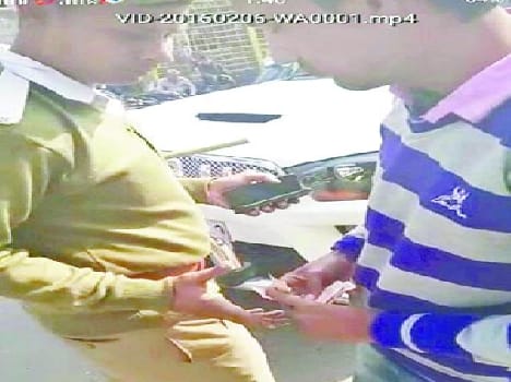 Traffic cop was caught on camera taking money