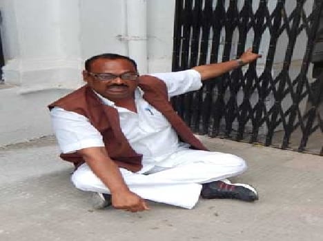 MLC candidate sitting on dharna in front of the DM's office.